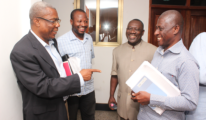 Mr Peter Mac Manu interacts with Mr Samuel Tettey, Director of Electoral Services of the EC after the IPAC meeting. Those with them are Mr Kwabena Bonfeh of the CPP and Mr O. B. Amoah of the NPP